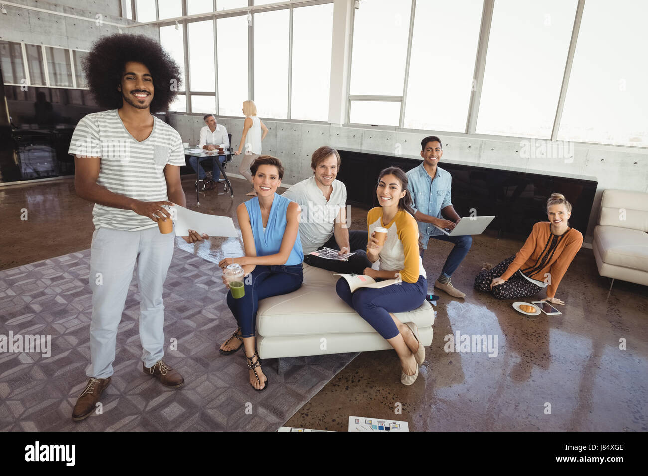 Portrait of smiling business people in creative office Stock Photo - Alamy