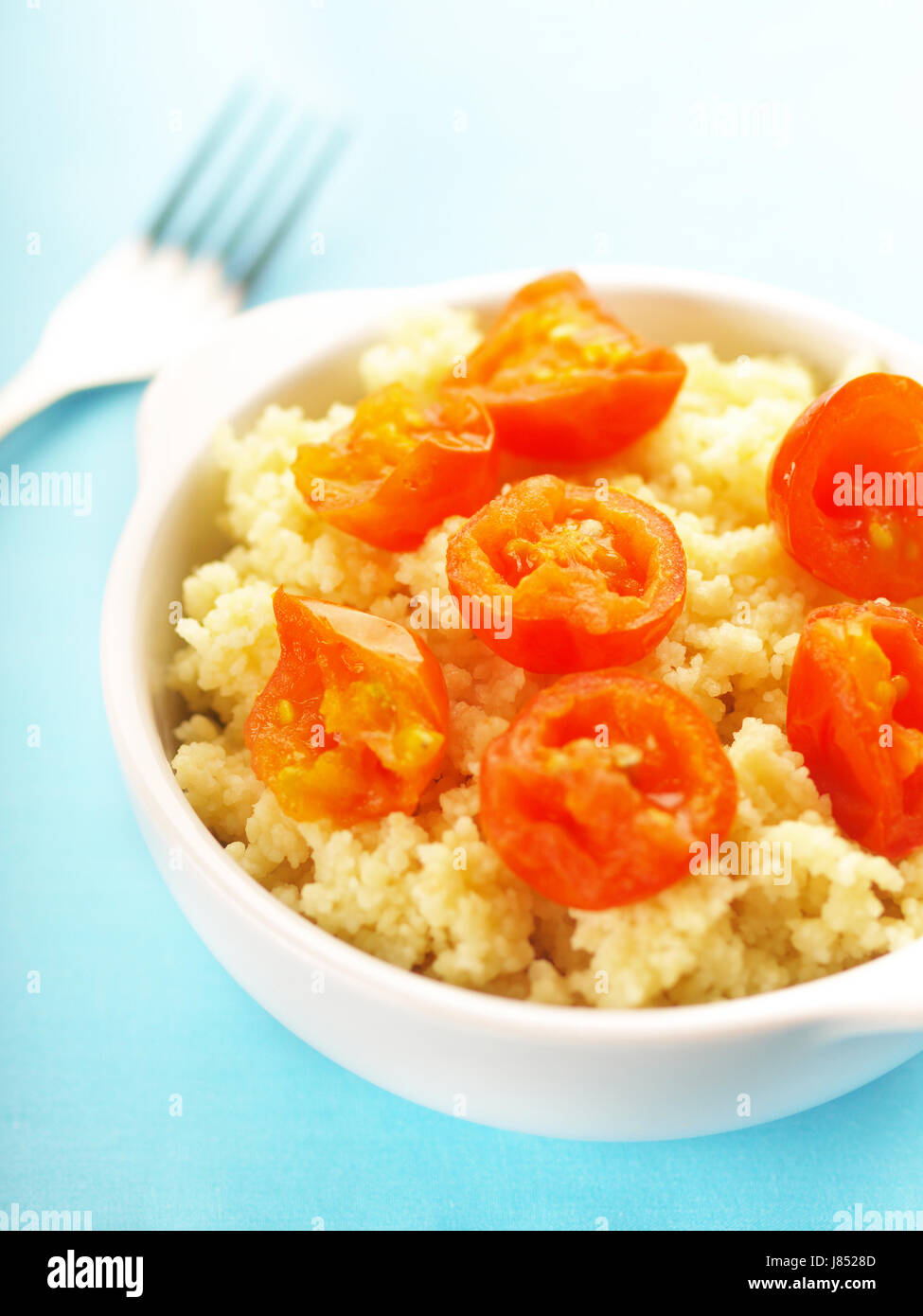 wheat tomato millet cooked starch carbohydrate couscous food aliment macro Stock Photo Alamy