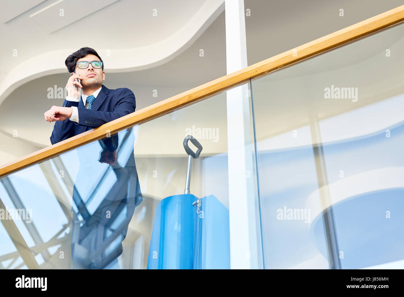 Young agent in suit consulting client Stock Photo - Alamy