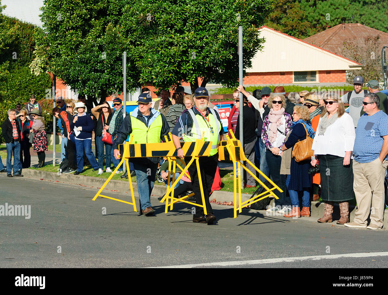 Crowd control operatives wearing hi vis jackets closing off the street during a festival, Berry, New South Wales, NSW, Australia Stock Photo