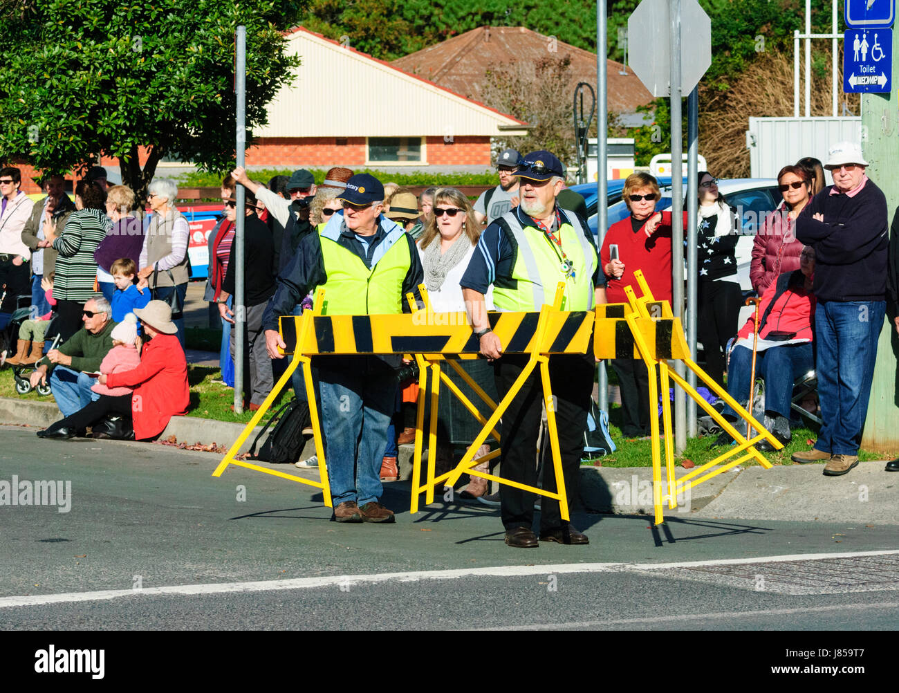 Crowd control operatives wearing hi vis jackets closing off the street during a festival, Berry, New South Wales, NSW, Australia Stock Photo