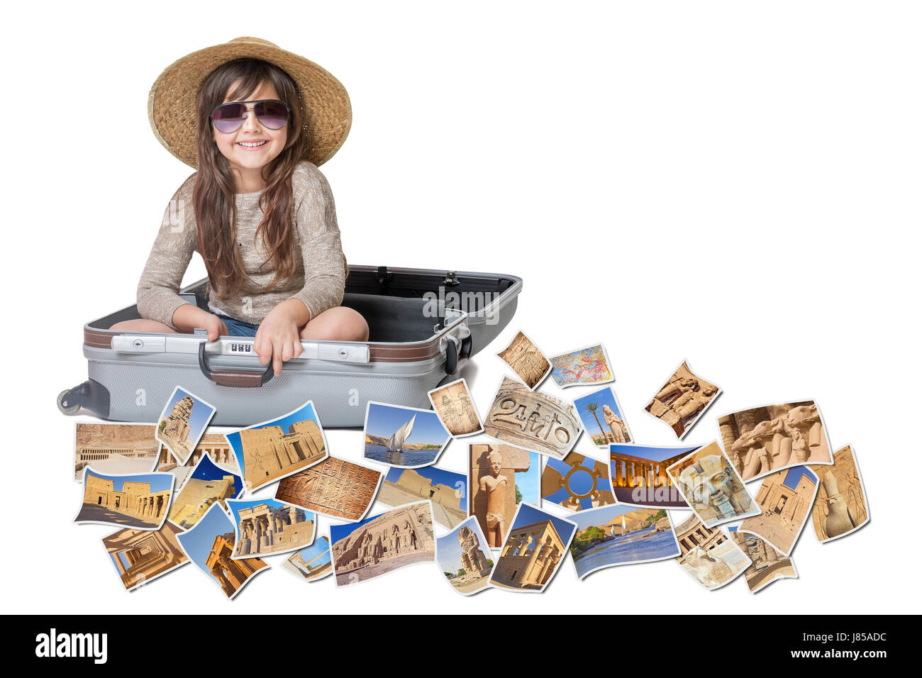 Long haired little girl with straw hat is sitting in a open suitcase. Photos of the sights of Egypt flies around the suitcase. All is on the white bac Stock Photo