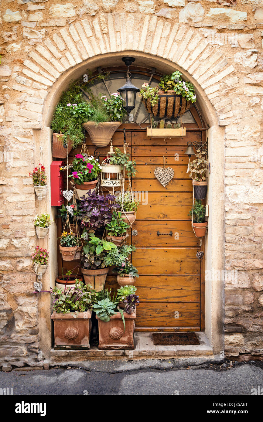 The beautiful wooden door in the old stone house decorated with lots of ...