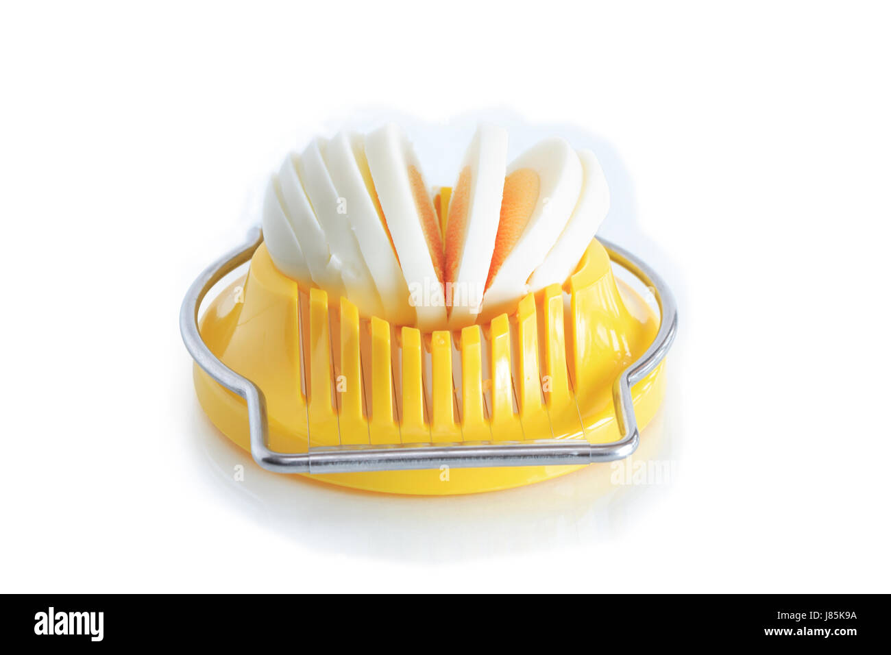 Modern yellow egg slicer on white background Stock Photo - Alamy