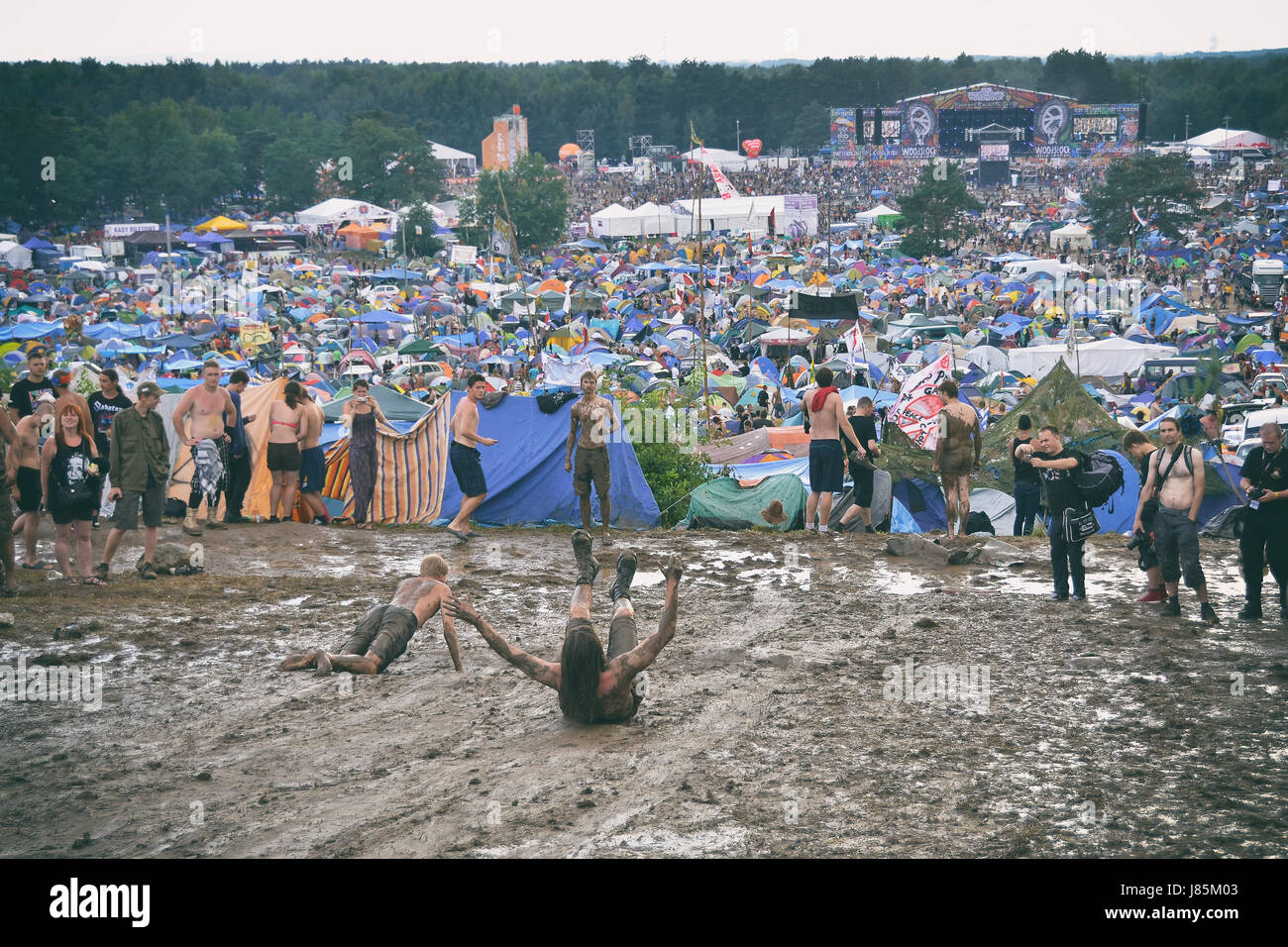 KOSTRZYN NAD ODRA, POLAND - AUGUST 4: Festival Przystanek Woodstock - fans bath in the mud in front camping  on August 4, 2012 in Kostrzyn Nad Odra, P Stock Photo