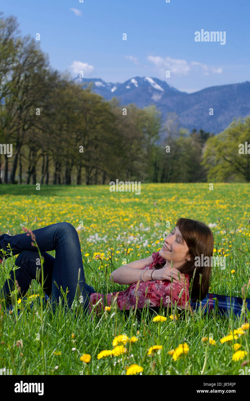 young woman relaxing on spring meadow Stock Photo