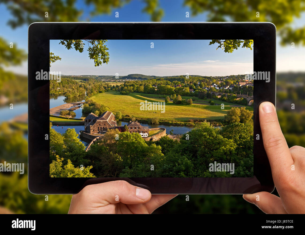 Hands holding tablet pc, with photo of Ruhr valley, Witten, Ruhr area, North Rhine-Westphalia, Germany Stock Photo
