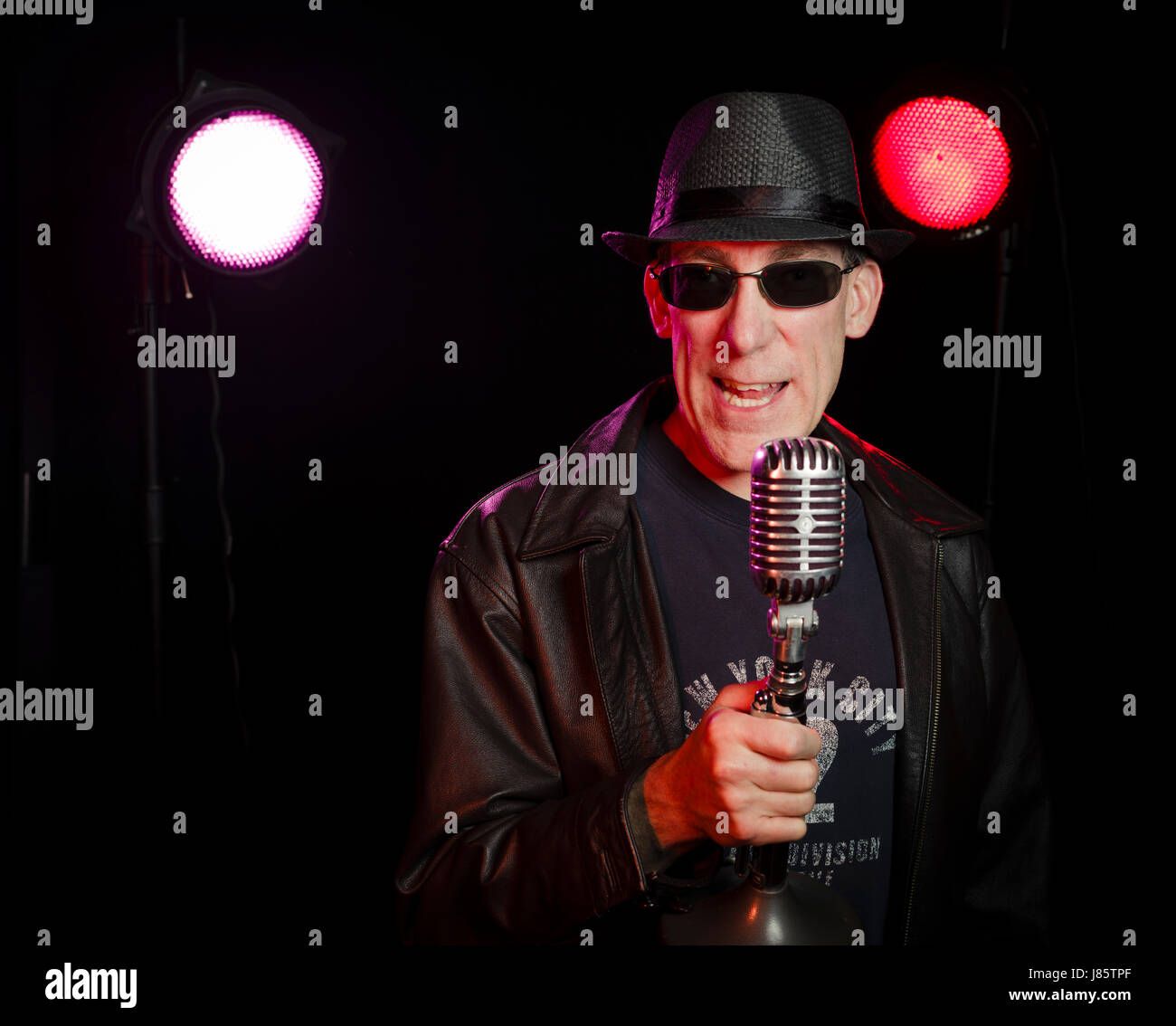 Standup comedian performing on stage with microphone Stock Photo Alamy