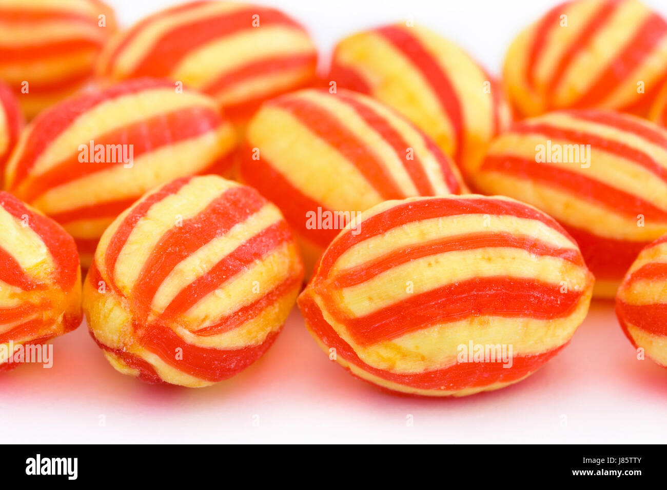sweets candy striped backdrop background red yellow close sweets closeup sugar Stock Photo
