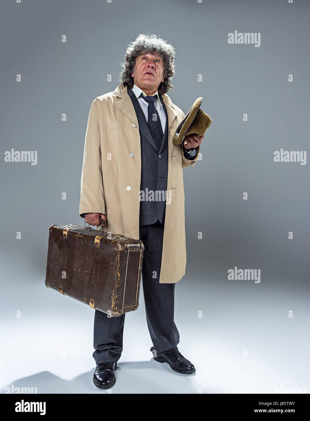 The senior man as detective or boss of mafia on gray studio background Stock Photo