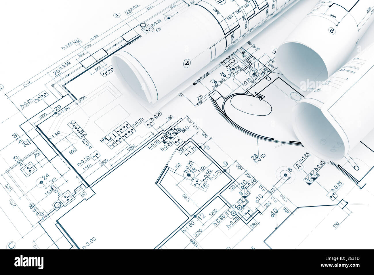 architectural background with rolls of technical drawings and blueprints Stock Photo