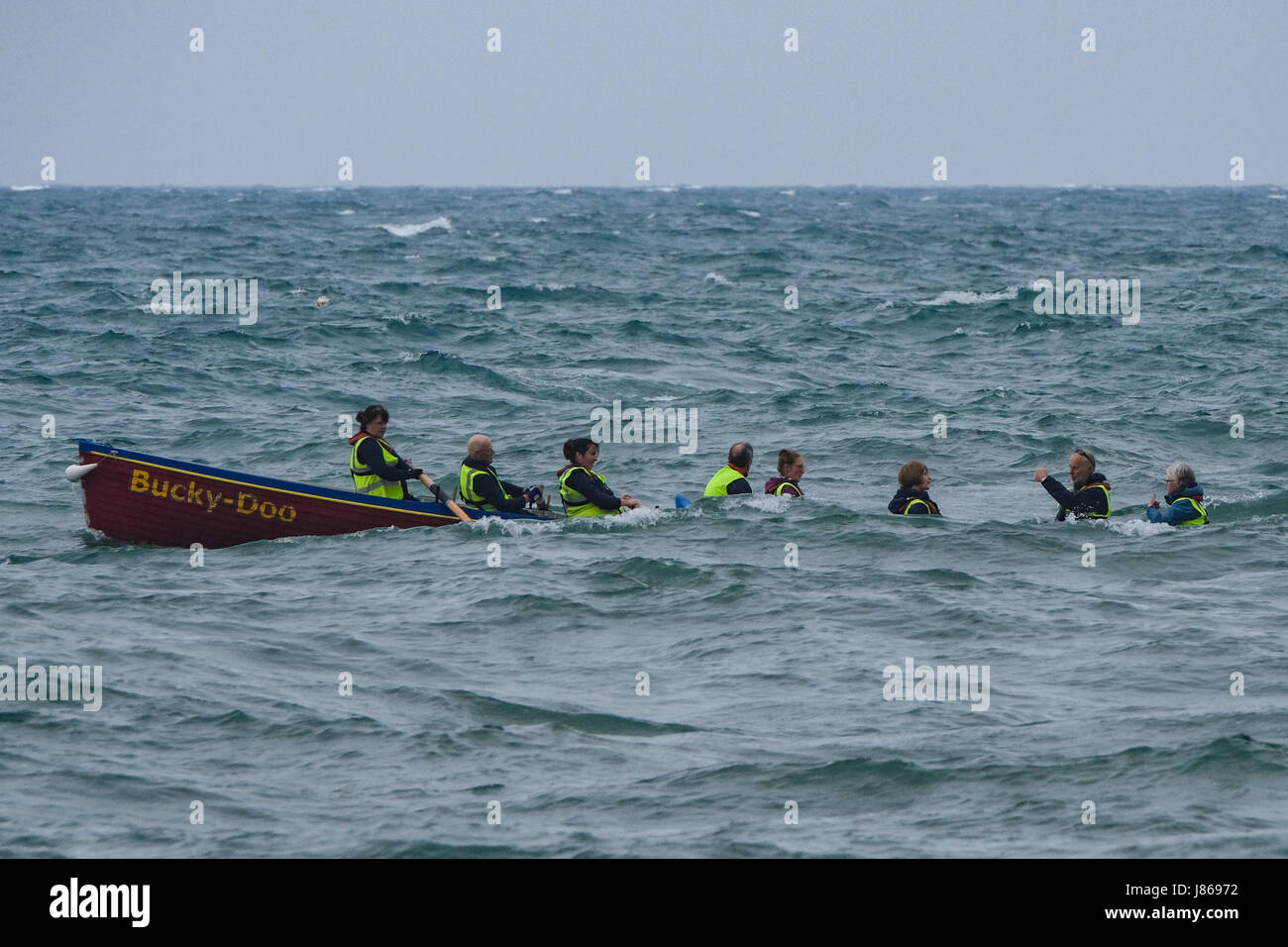 West Bay, Dorset, UK. 27th May, 2017. Bridport Gig club members take the "Bucky-Doo" gig out in decidedly choppy waters after a night of thunder and rain on the Dorset coast. Gig racing is a rapidly expanding sport. There are over 50 clubs and some 140 boats in the South West of England. Credit: Tom Corban/Alamy Live News Stock Photo