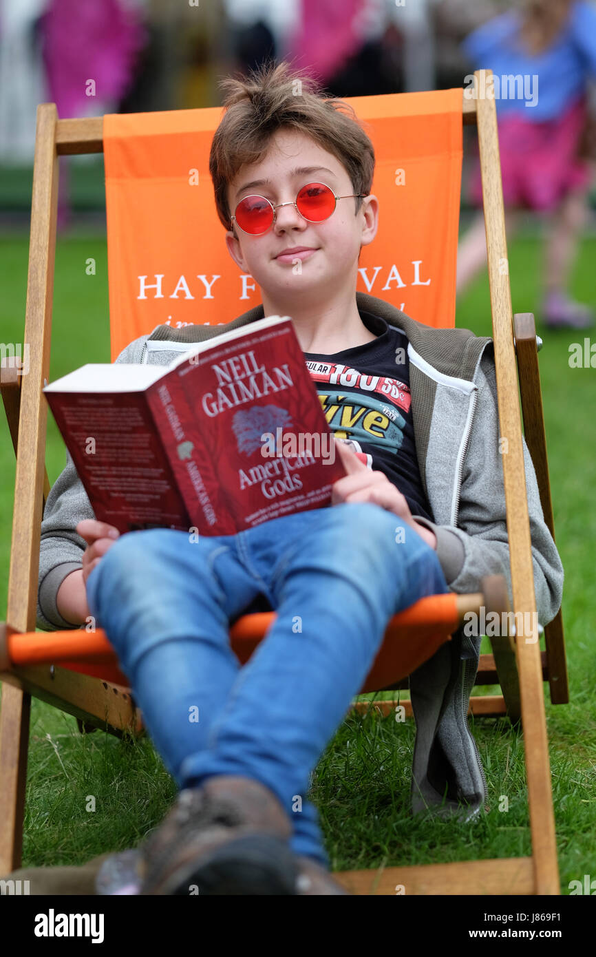 Hay Festival 2017 - Hay on Wye, Wales, UK - May 2017 - A young teen reader enjoys his Neil Gaiman book -  Steven May / Alamy Live News Stock Photo