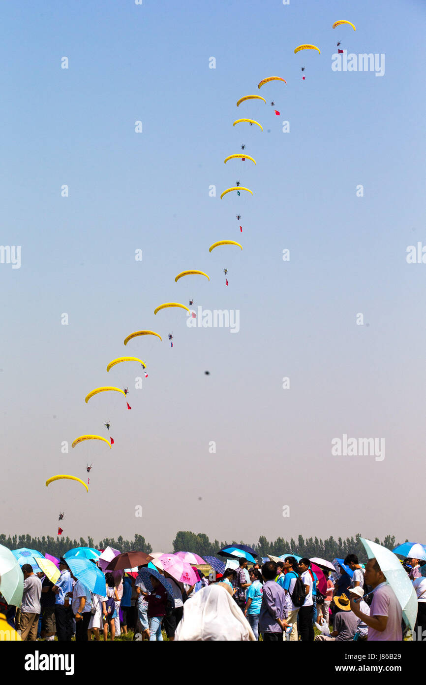 Anyang. 27th May, 2017. Sportsmen perform parachuting during an air show in Anyang of central China's Henan Province, May 27, 2017. Credit: Li Gang/Xinhua/Alamy Live News Stock Photo