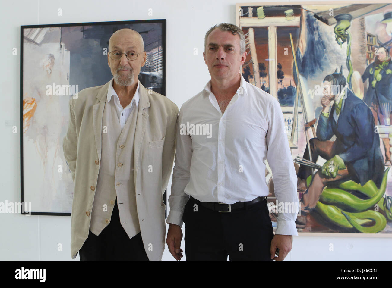 Aschersleben, Germany. 27th May, 2017. Painters Arno Rink and Neo Rauch stand next to each other at the graphic foundation Neo Rauch in Aschersleben, Germany, 27 May 2017. Painters Neo Rauch's and Arno Rink's works meet at the sixth exhibition of the graphic foundation since its establishment. Photo: Matthias Bein/dpa-Zentralbild/dpa/Alamy Live News Stock Photo