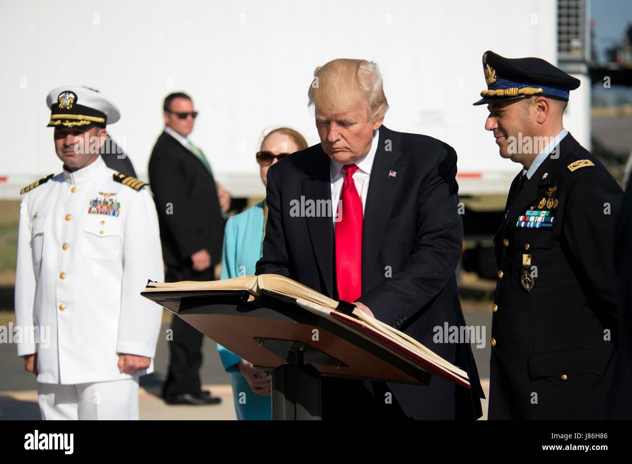 U.S. President Donald Trump signs the Albo d’Onore, the Sigonella Italian Air Force base guest book during a stopover to visit Naval Air Station Sigonella before returning home from his nine-day overseas trip May 27, 2017 in Sigonella, Italy. Stock Photo
