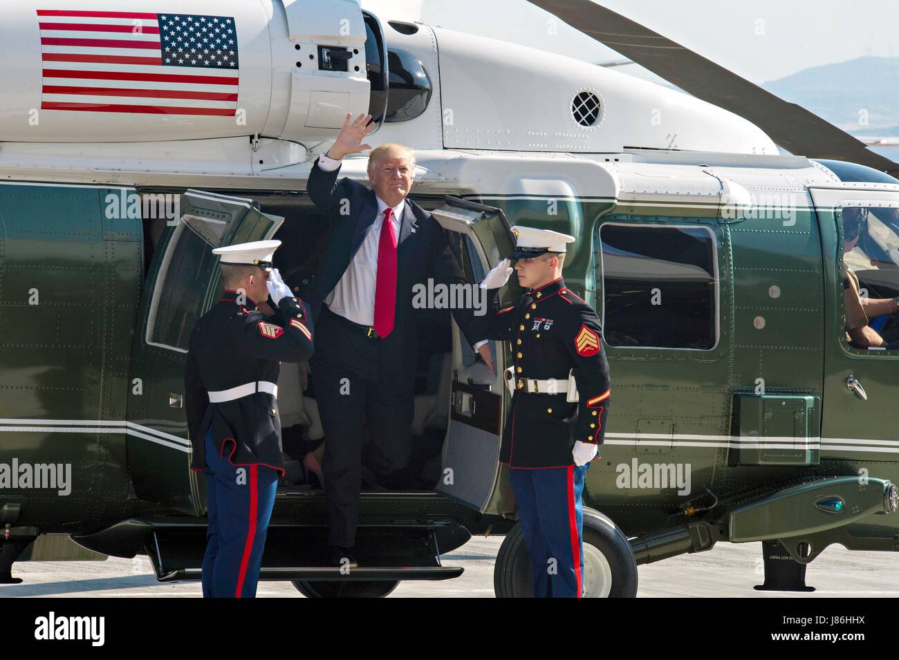 U.S. President Donald Trump waves as he arrives by Marine One