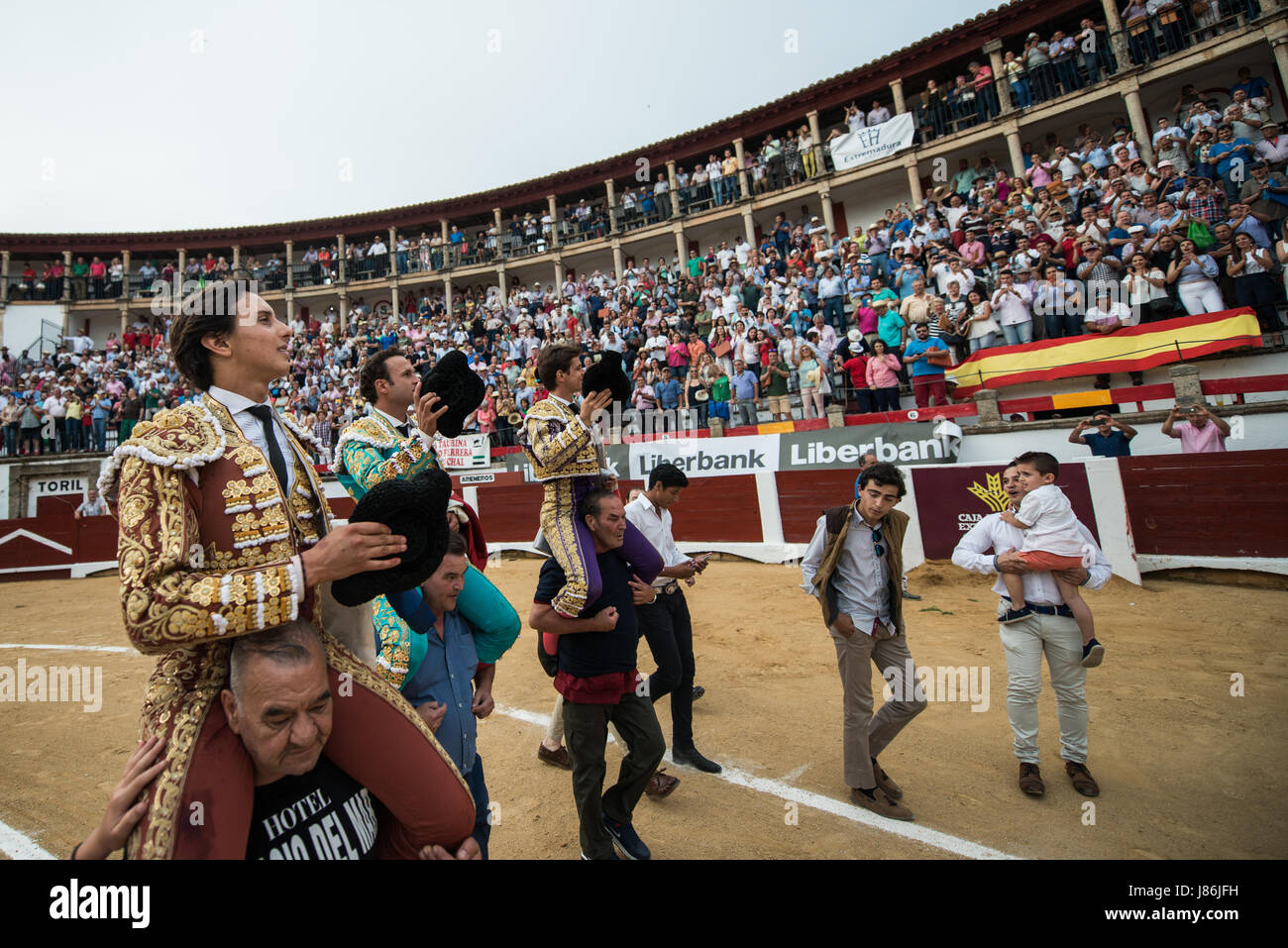 Caceres, Spain. 27th May, 2017. Peruvian bullfighter Andres Roca Rey and Spanish bullfighters Antonio Ferrera and Julián Lopez 'El Juli' are carried on the shoulders of bullfighting fans during the San Fernando Fair at the bullring in Cáceres, Spain. Credit: Esteban Martinena Guerrero/Alamy Live News Stock Photo