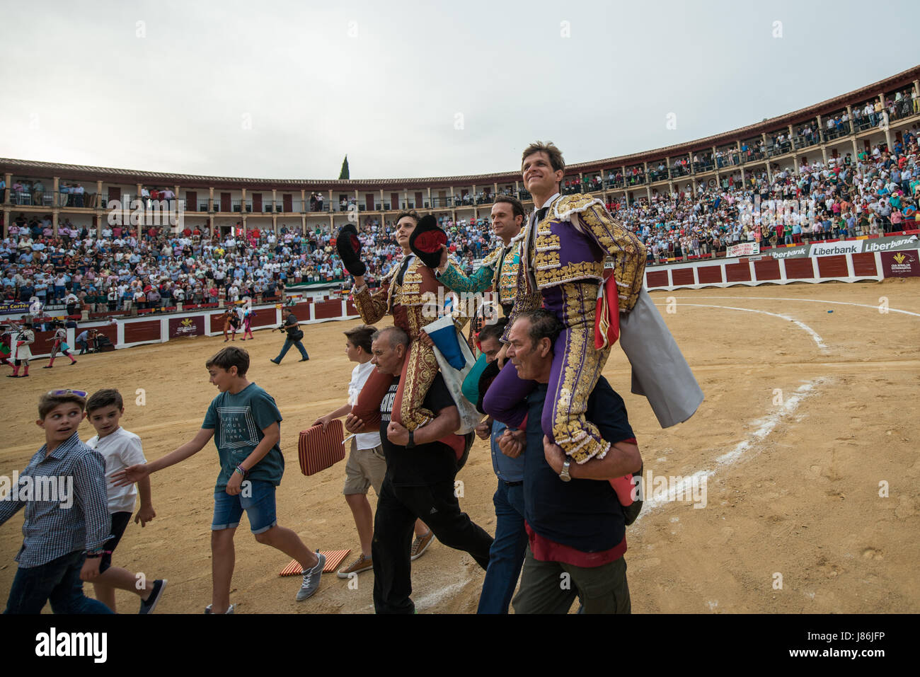 Caceres, Spain. 27th May, 2017. Peruvian bullfighter Andres Roca Rey and Spanish bullfighters Antonio Ferrera and Julián Lopez 'El Juli' are carried on the shoulders of bullfighting fans during the San Fernando Fair at the bullring in Cáceres, Spain. Credit: Esteban Martinena Guerrero/Alamy Live News Stock Photo
