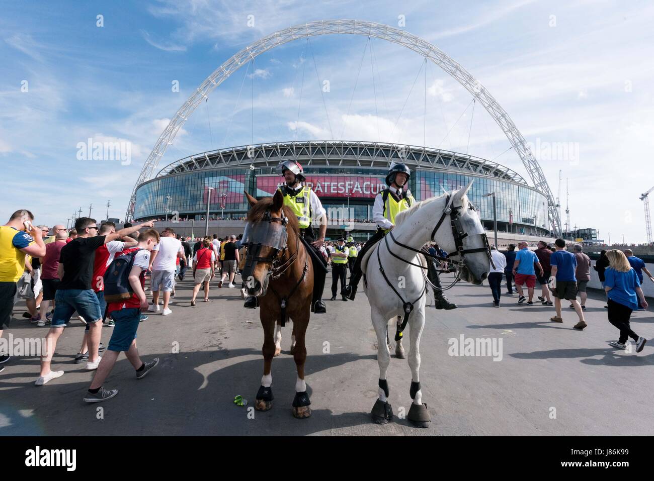 London, Britain. 27th May, 2017. Mounted policemen are on patrol as security precautions are stepped up for Arsenal and Chelsea fans arriving at Wembley stadium for the FA Cup football finals in London, Britain, on May 27, 2017. The security level was in response to Manchester Arena bombing when 22 people died and 66 people were injured in one of the most deadly attacks in the UK. Credit: Ray Tang/Xinhua/Alamy Live News Stock Photo