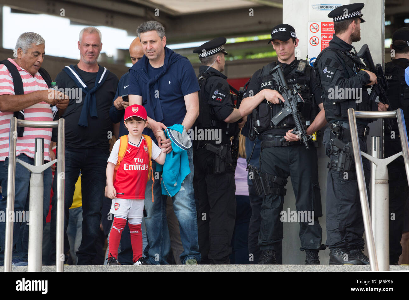 London, Britain. 27th May, 2017. Armed policemen are on patrol as security precautions are stepped up for Arsenal and Chelsea fans arriving at Wembley stadium for the FA Cup football finals in London, Britain, on May 27, 2017. The security level was in response to Manchester Arena bombing when 22 people died and 66 people were injured in one of the most deadly attacks in the UK. Credit: Ray Tang/Xinhua/Alamy Live News Stock Photo
