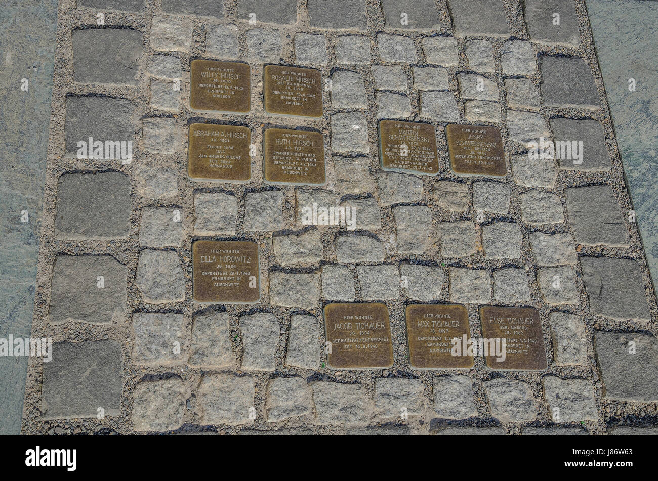 Stolpersteine are concrete blocks which are laid into the pavement in front of the last voluntarily chosen places of residence  Nazi victims. Stock Photo