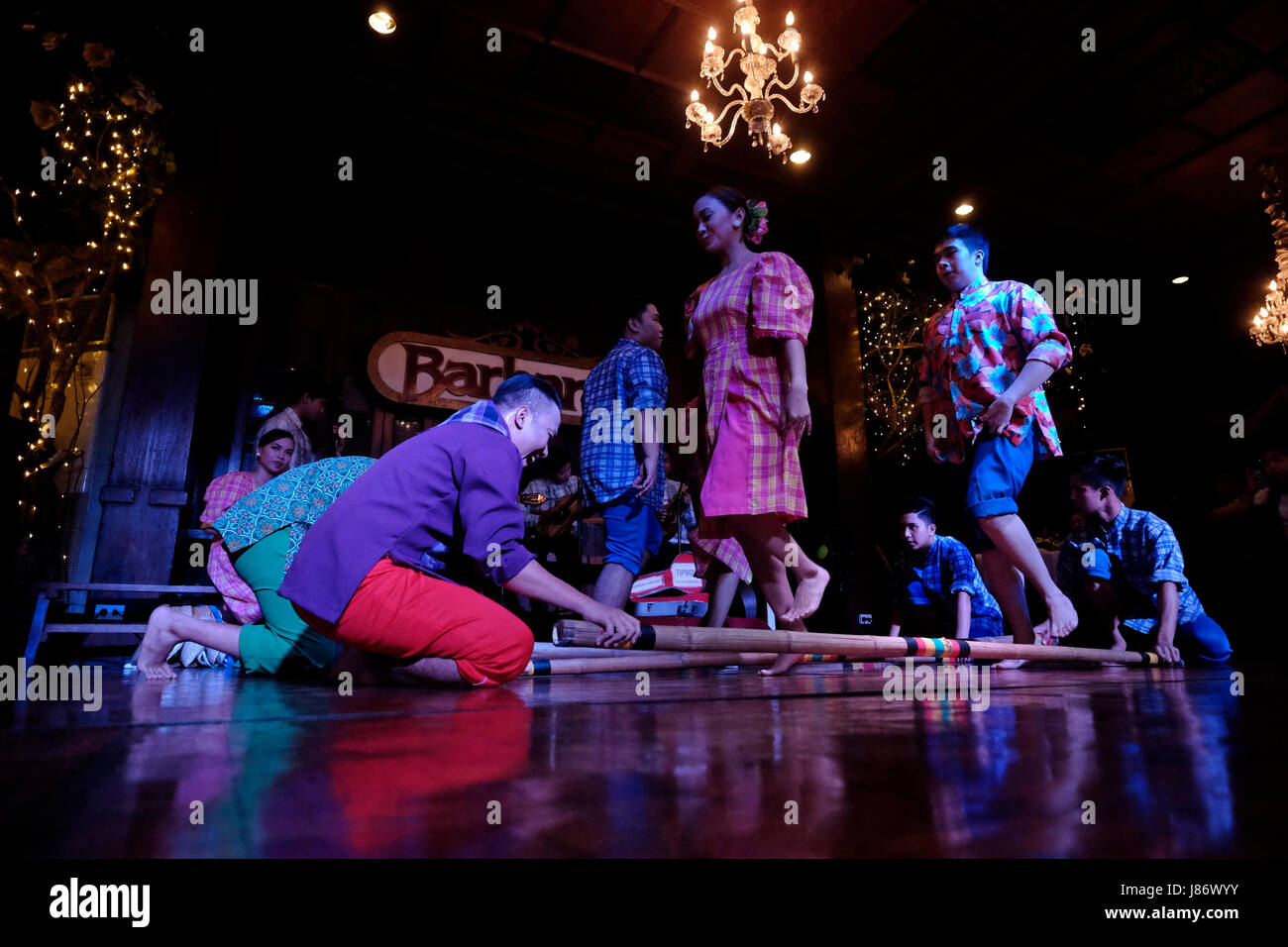 Filipino dancers performing the Tinikling a traditional Philippine folk dance which originated during the Spanish colonial era at Barbara's Casa Manila a restaurant located inside the historic walled city of Manila referred to as Intramuros in the city of Manila capital of the Philippines Stock Photo