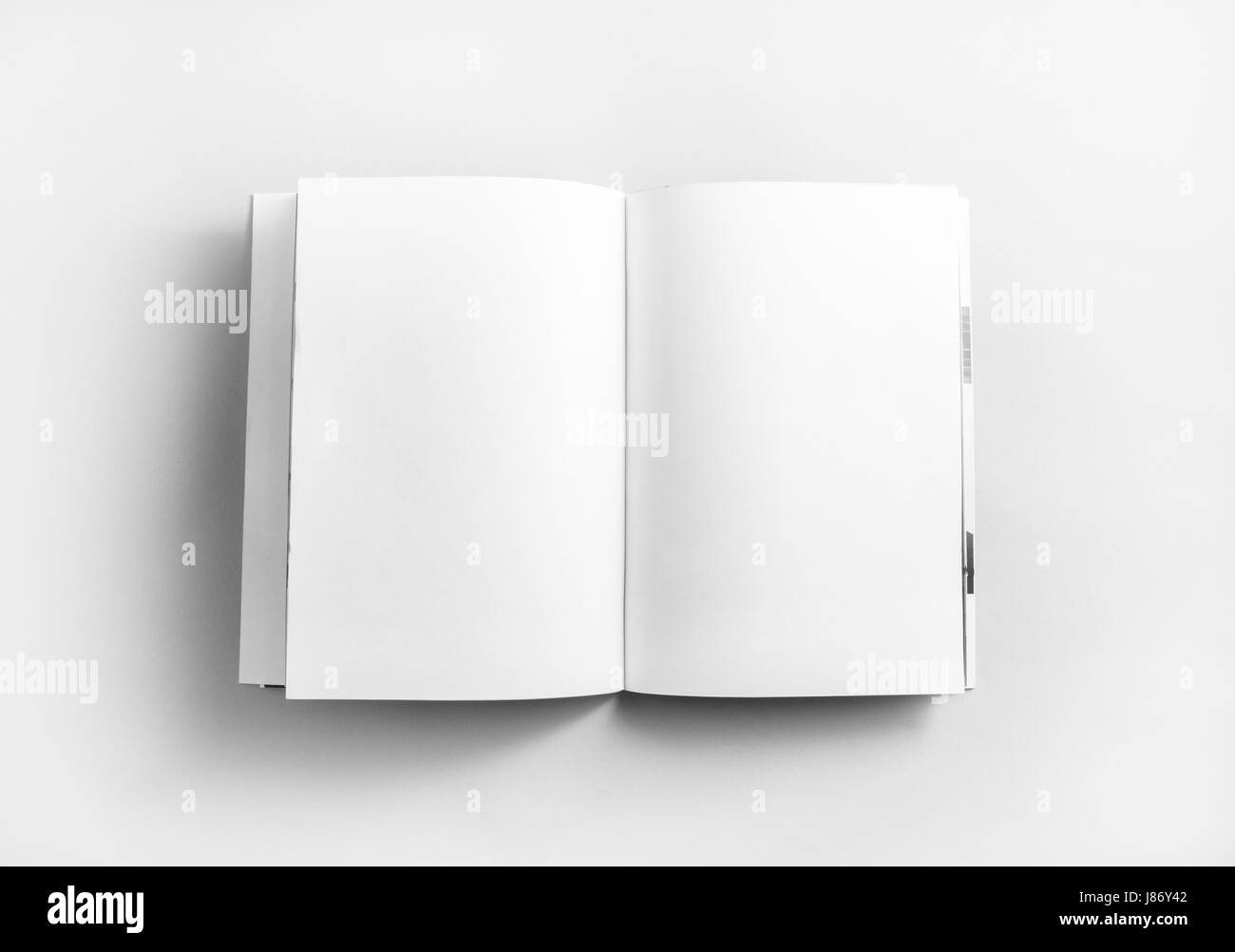Blank open book, brochure or magazine on paper background. Mock-up for graphic designers portfolios. Responsive design mockup. Top view. Stock Photo