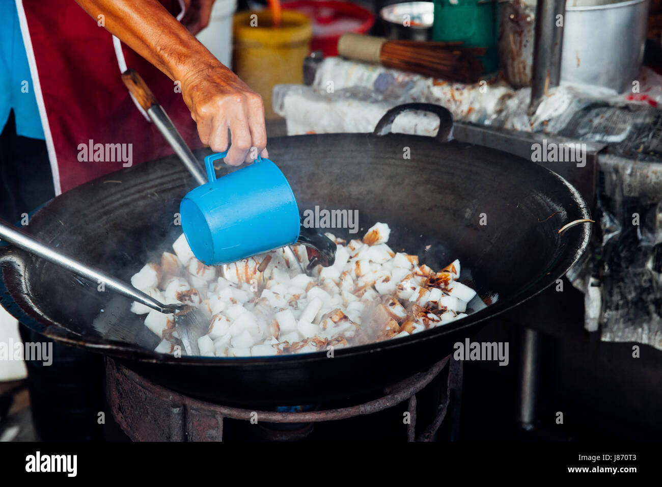 GEORGE TOWN, MALAYSIA - MARCH 23, 2016: Man is cooking at Kimberly Street Food Night Market on March 23, 2016 in George Town, Malaysia. Stock Photo