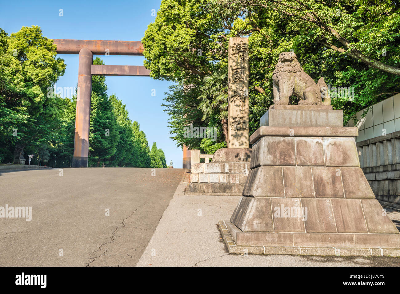 Daiichi Torii Shinto Gate and  Stone Lion at the entrance The Imperial Shrine of Yasukuni, informally known as the Yasukuni Shrine, Tokyo, Japan Stock Photo
