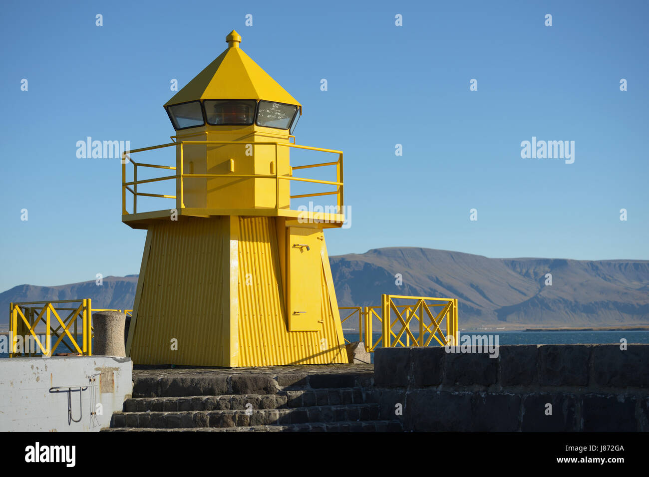 Yellow Lighthouse in the harbour entrance, Reykjavik, Iceland Stock Photo
