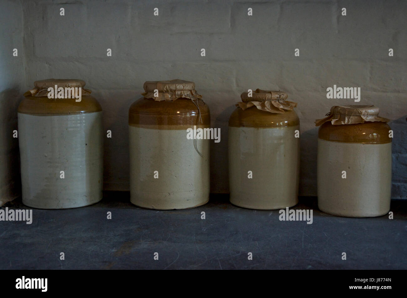 Old Fashioned Stone Storage Jars On A Pantry Shelf Stock Photo