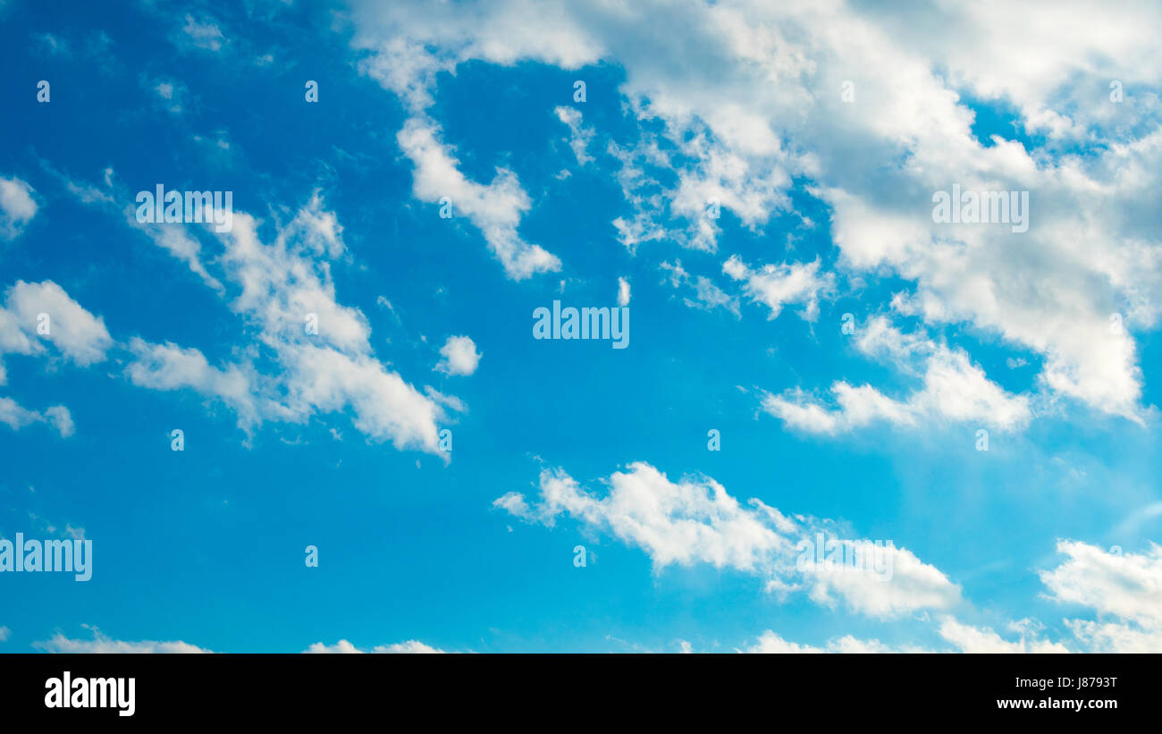 Blue sky with puffy white clouds Stock Photo - Alamy