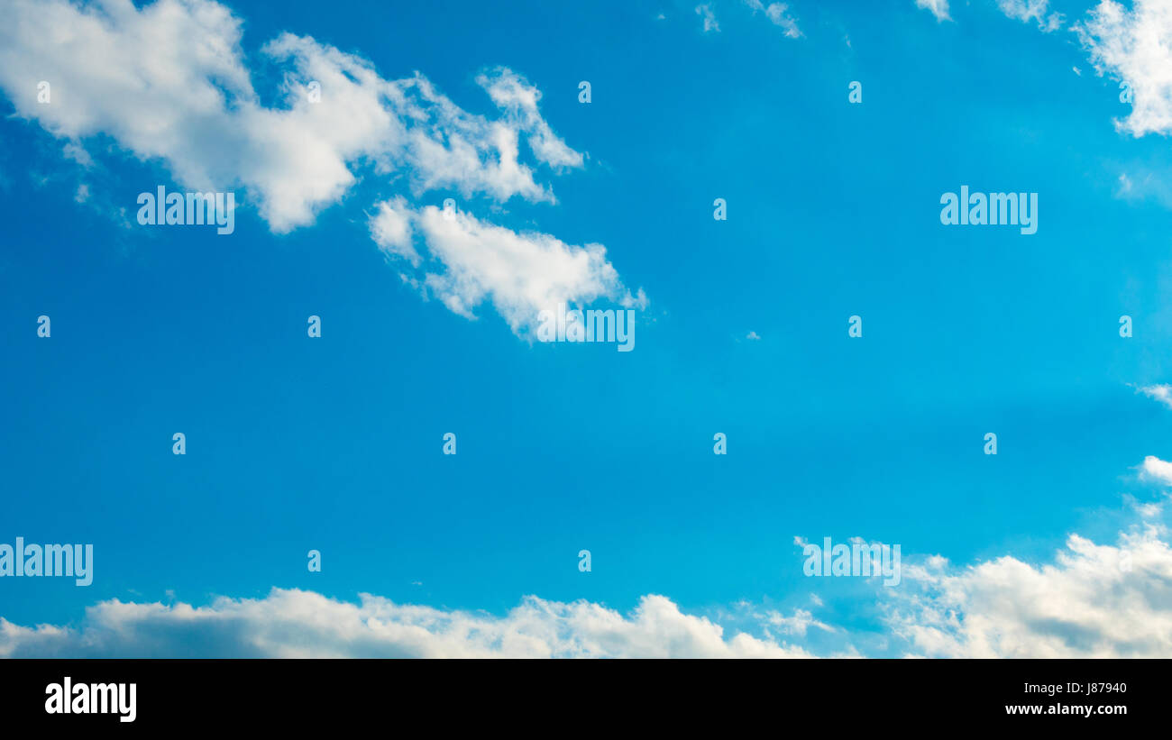 Blue sky with puffy white clouds Stock Photo - Alamy