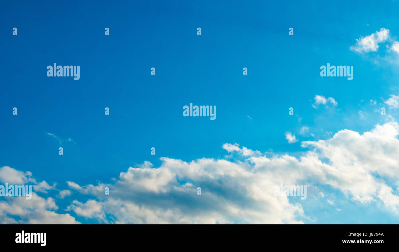 Blue sky with puffy white clouds Stock Photo - Alamy