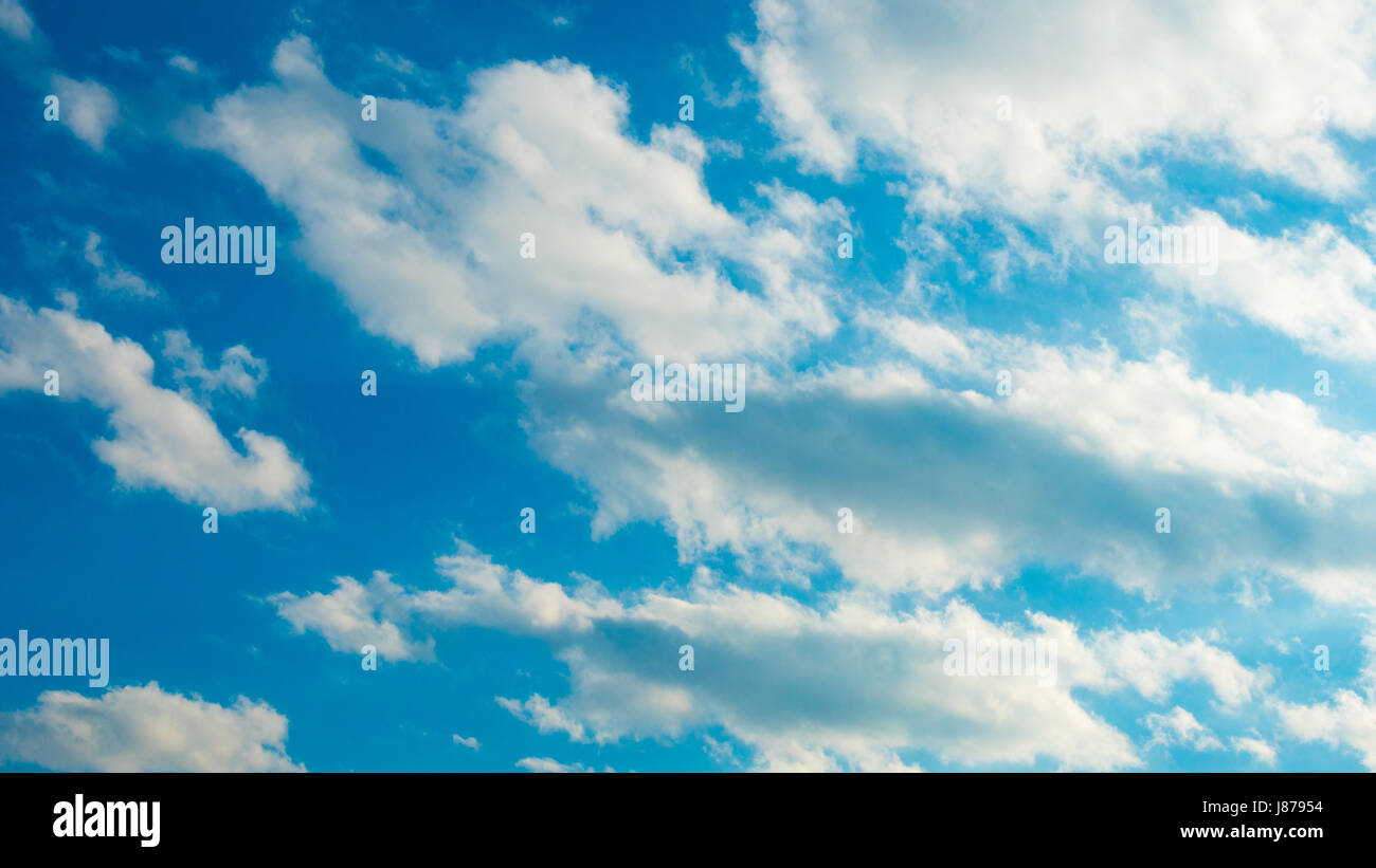 Blue sky with puffy white clouds Stock Photo - Alamy