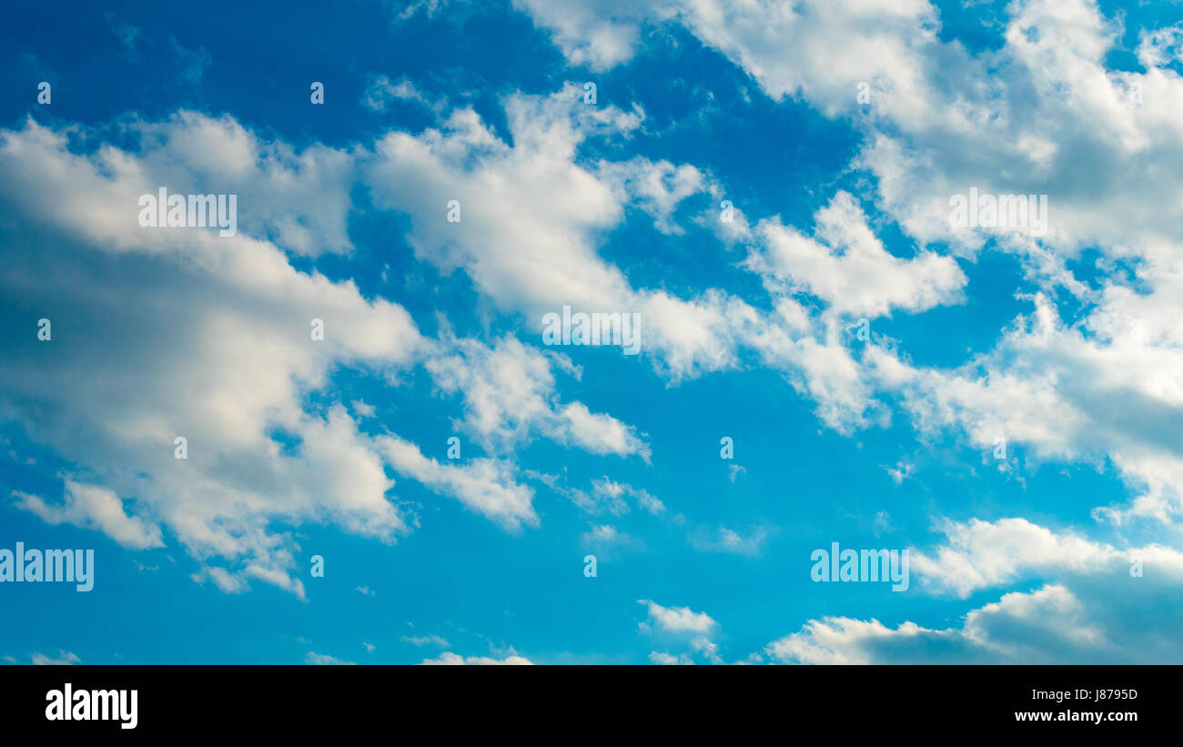 Blue sky with puffy white clouds Stock Photo - Alamy