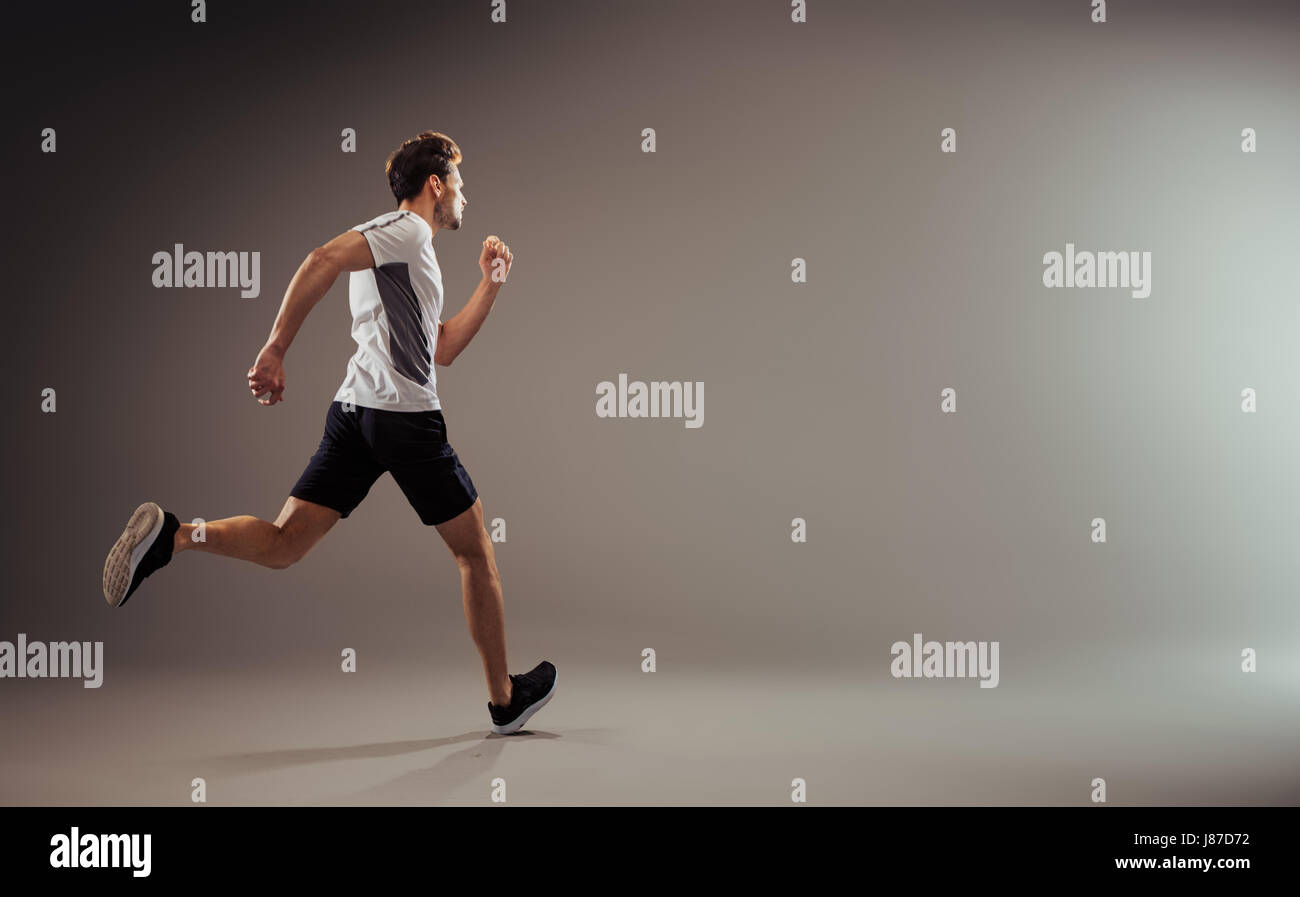 Young and active jogger running - isolated Stock Photo - Alamy