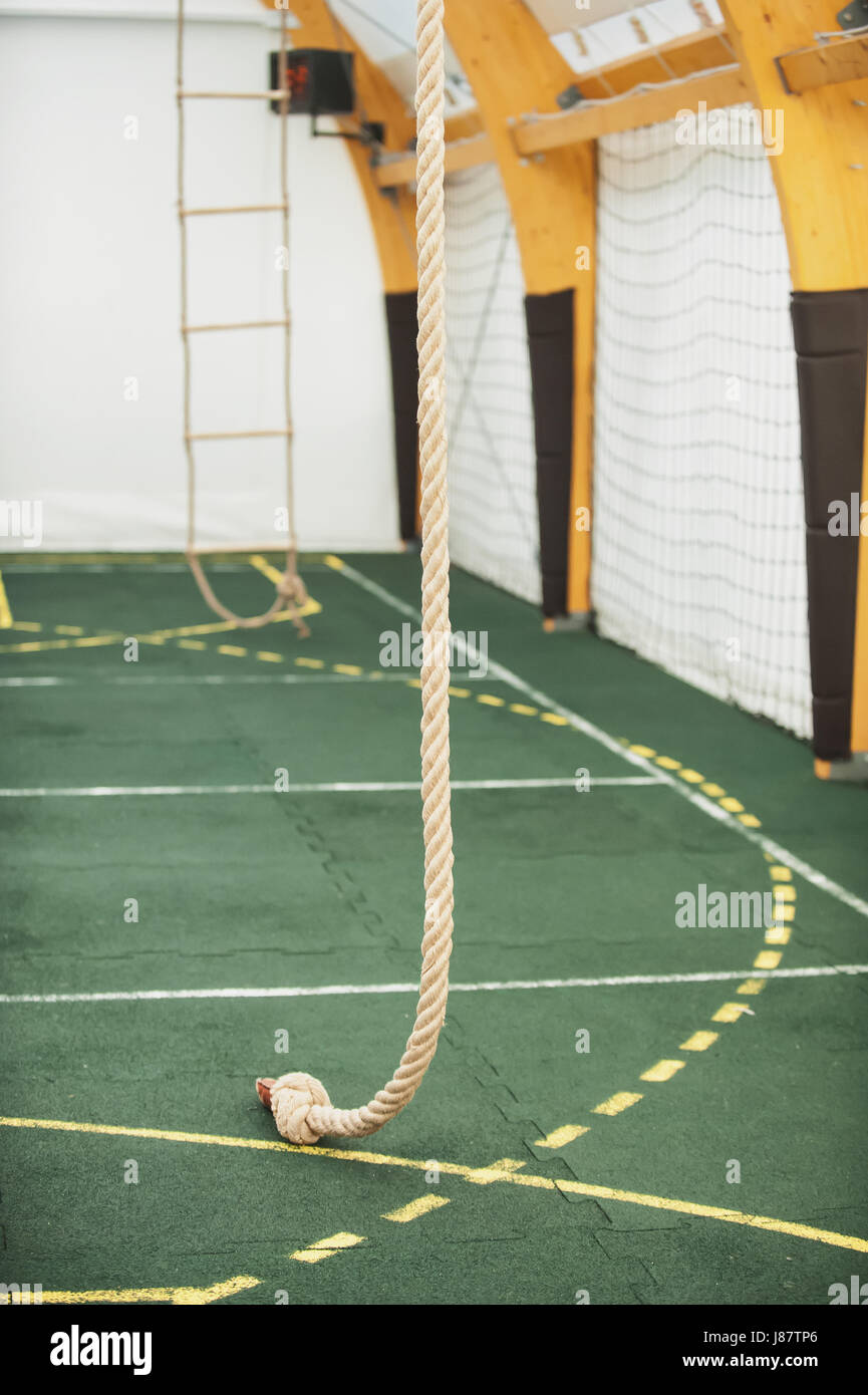 Rope for climbing in sport school gym hall. Indoor Stock Photo - Alamy