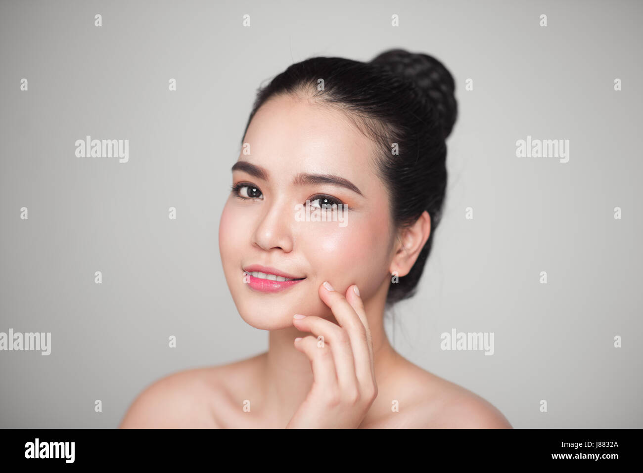 Happy smiling beautiful asian woman touching her face Stock Photo - Alamy