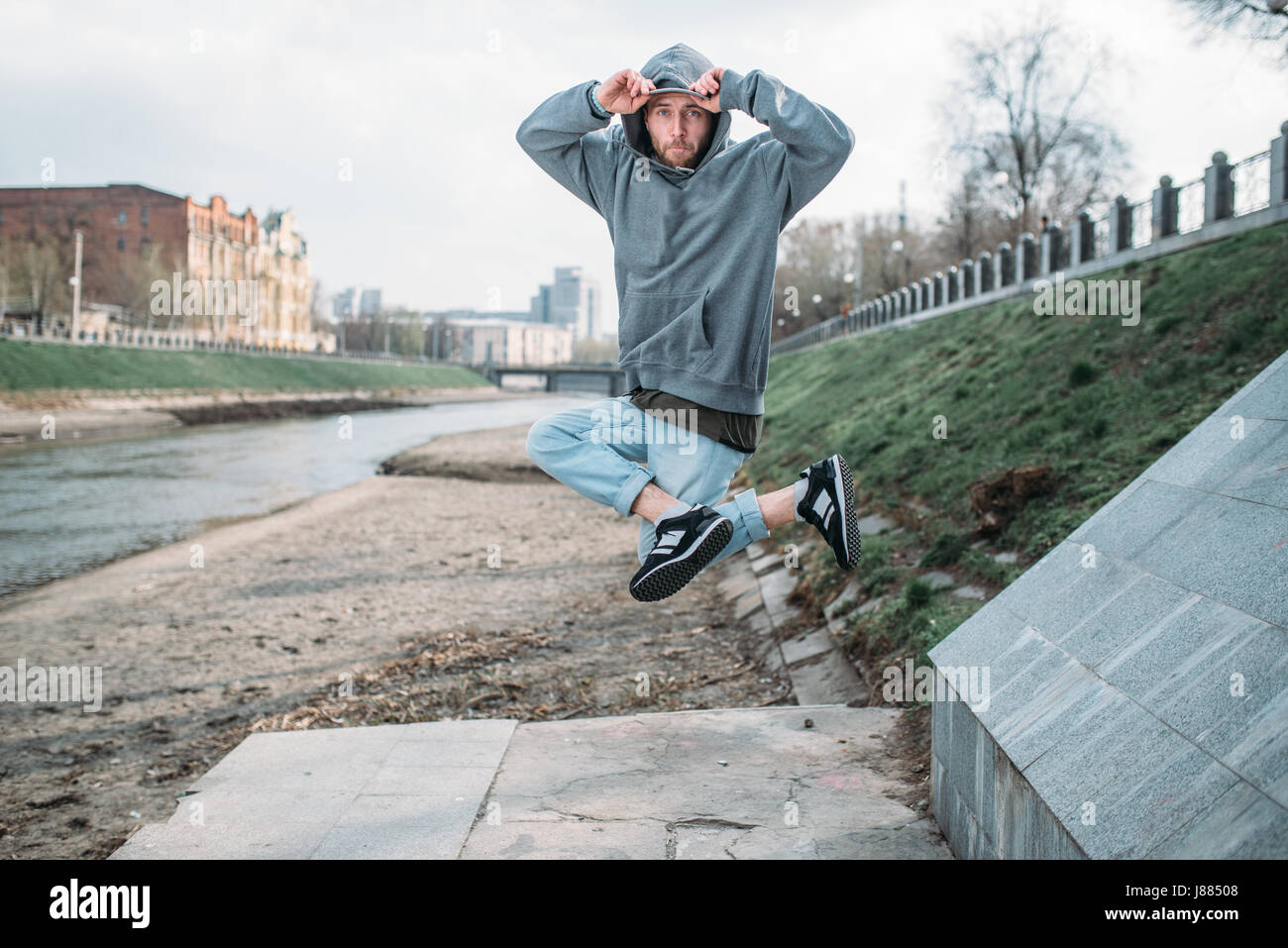 Male rapper posing on the street, urban dancing. Modern dance style ...
