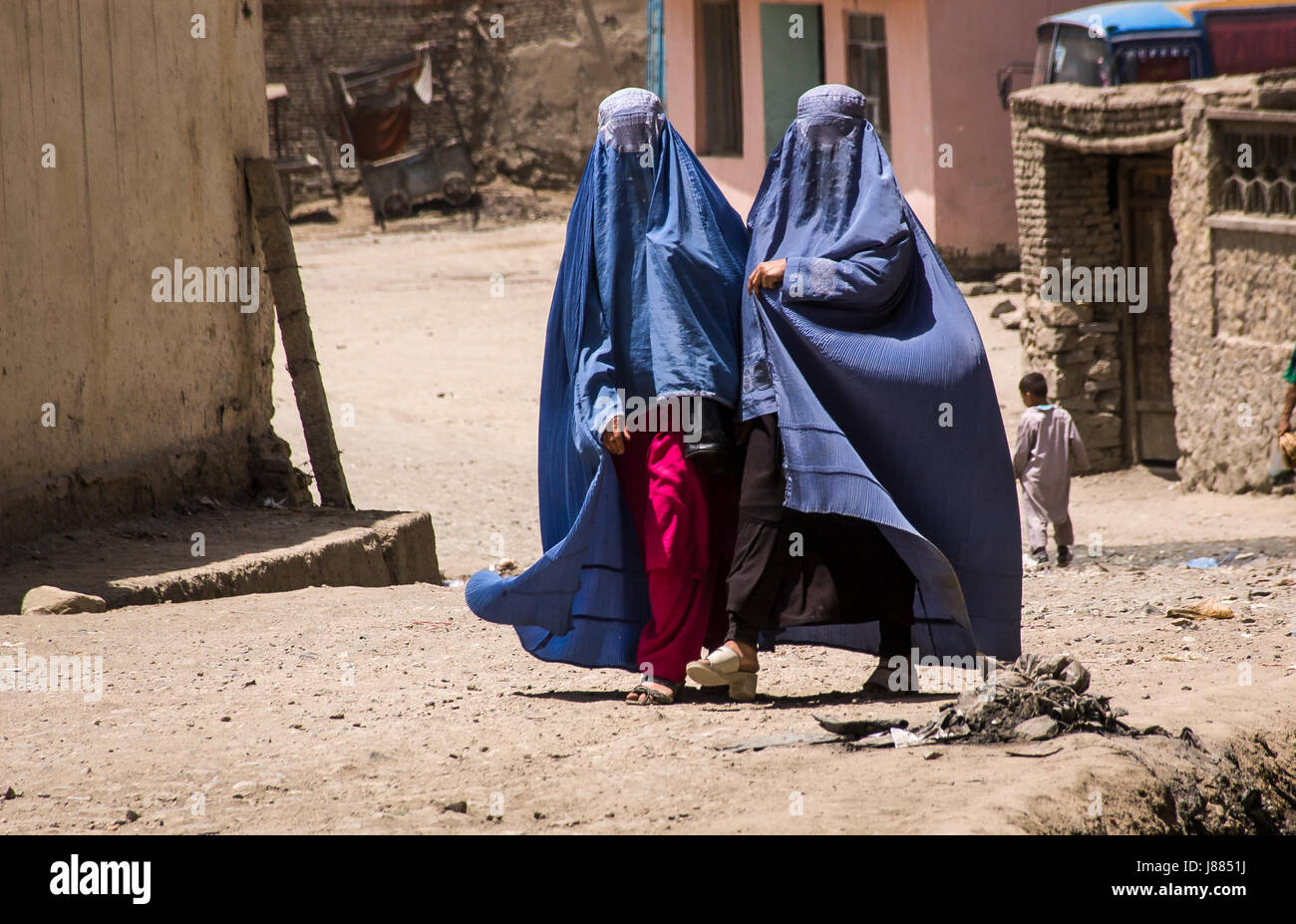 Afghan women in burqas walking in the street in Kabul Stock Photo