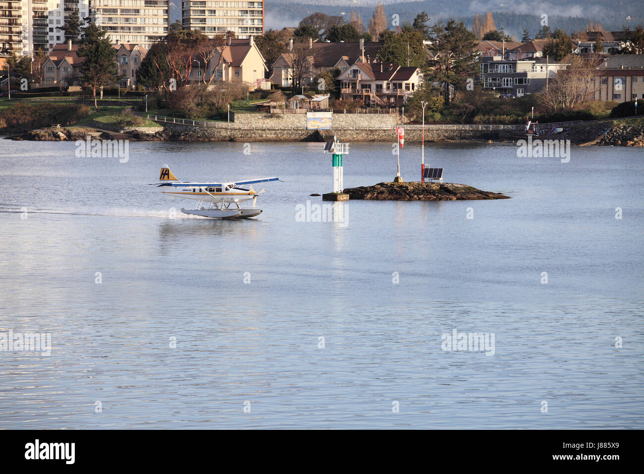 Tourists in a float plane landing in Victoria Harbor in Victoria Briitish Columbia. Stock Photo