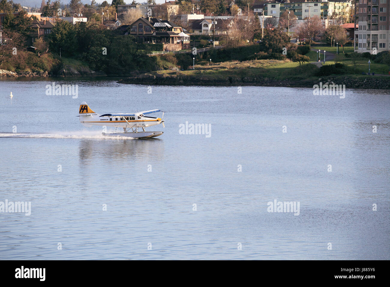 Tourists in a float plane landing in Victoria Harbor in Victoria Briitish Columbia. Stock Photo