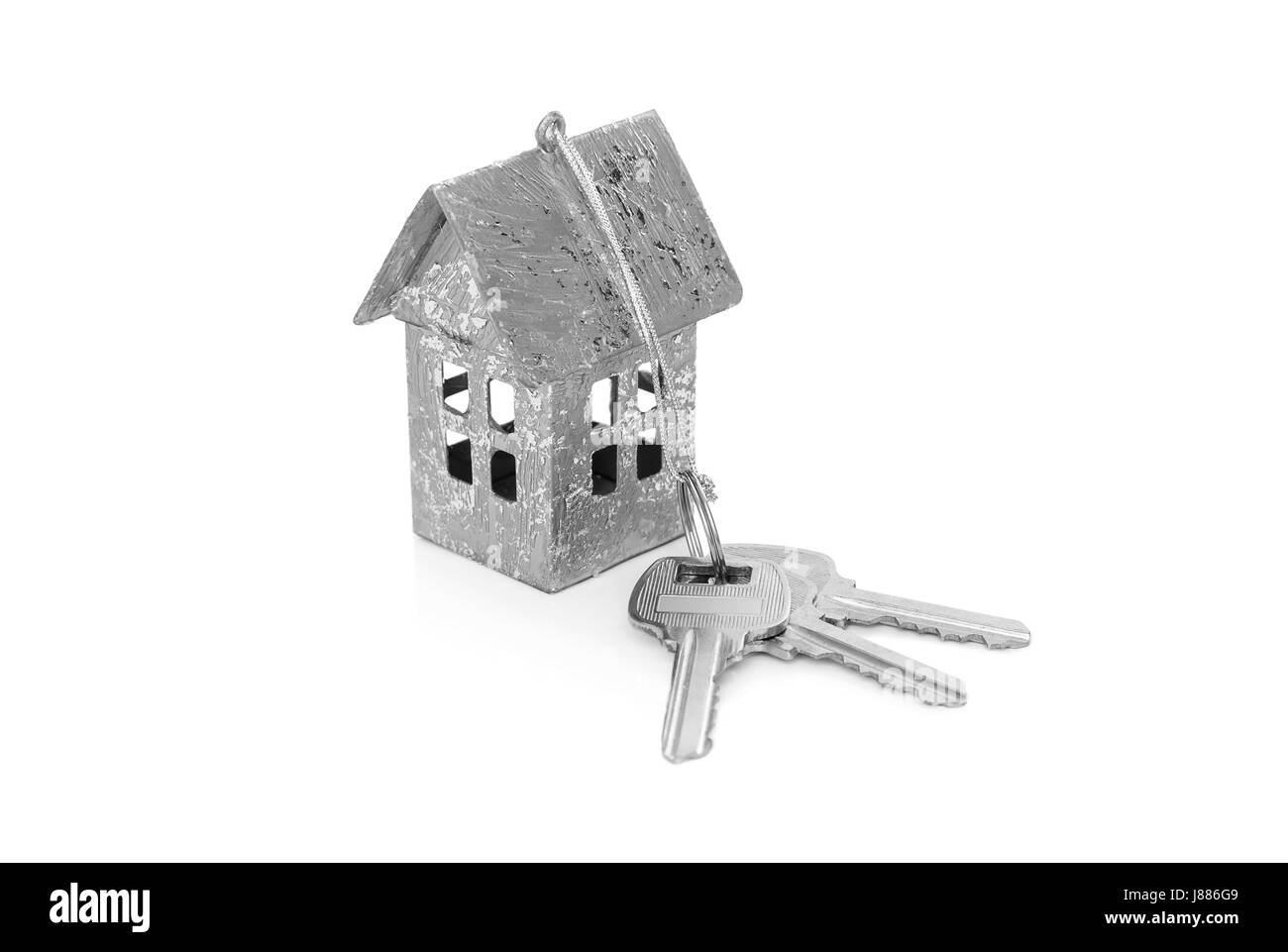 Model of the house with keys isolated on white background. Stock Photo