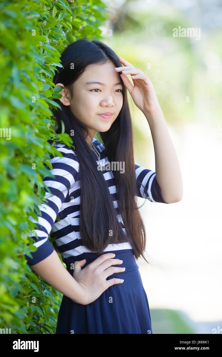 portrait of younger asian teen with happiness emotion and smiling face in  green park Stock Photo - Alamy