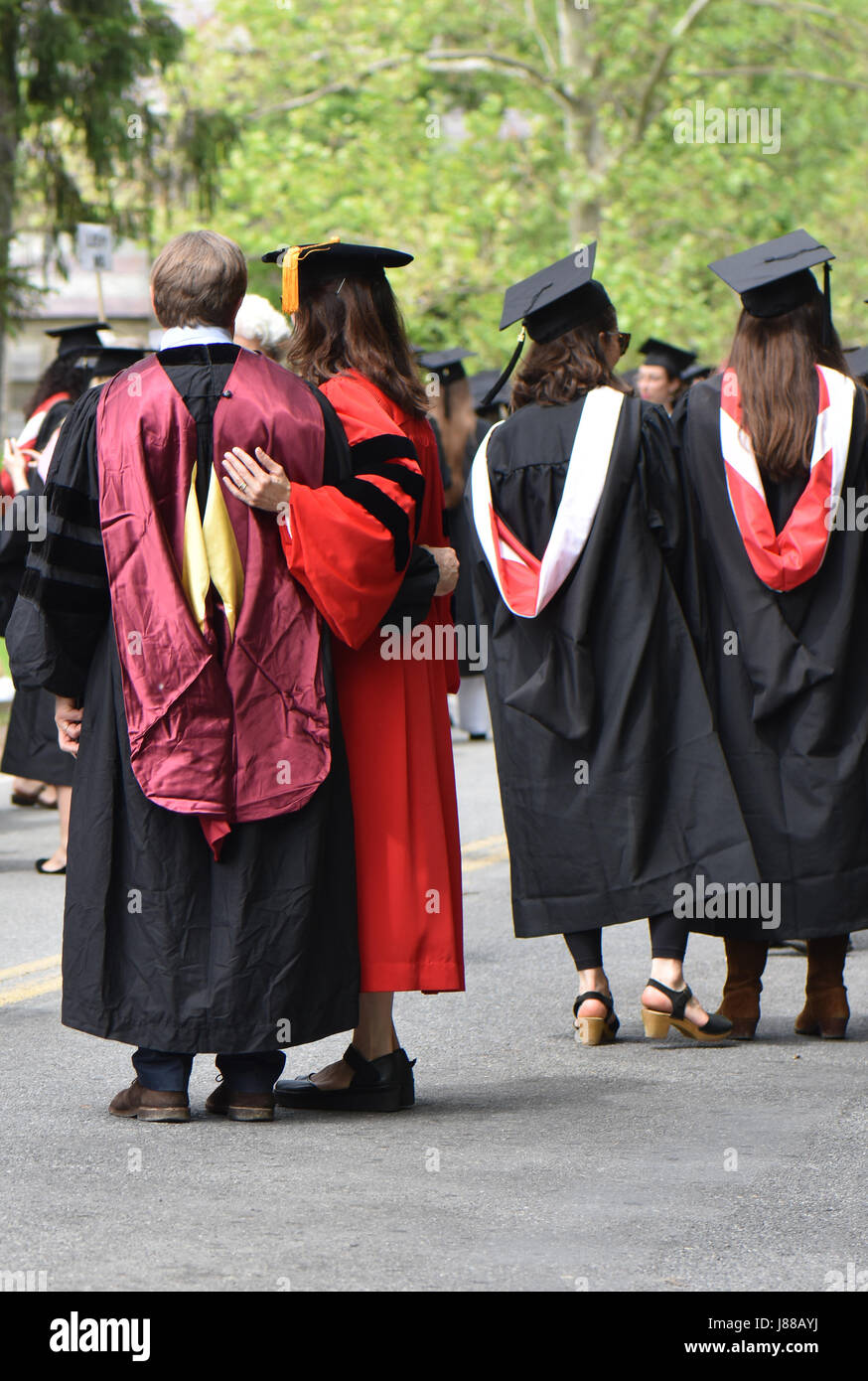 Dressed in graduation robes and caps students and parents celebrate the day Stock Photo Alamy