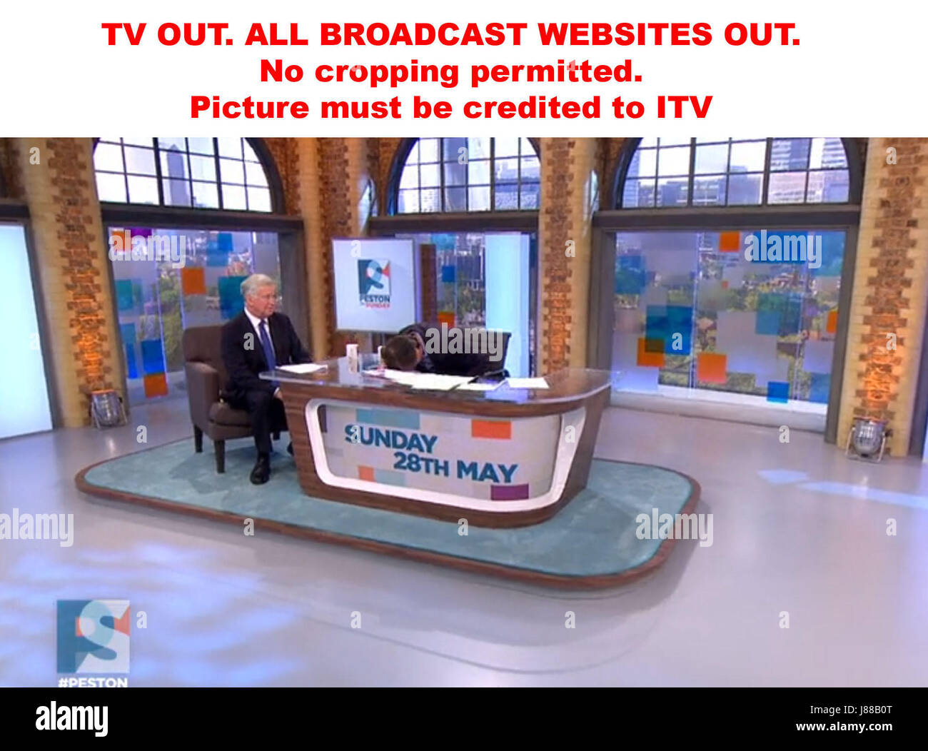 TV OUT. ALL BROADCAST WEBSITES OUT. No cropping permitted. Picture must be credited to ITV. We are advised that videograbs should not be used more than 48 hours after the time of original transmission, without the consent of the copyright holder. Video grab taken from ITV of Robert Peston banging his head on the desk following a heated exchange with Sir Michael Fallon (left) on the Peston On Sunday show. Stock Photo