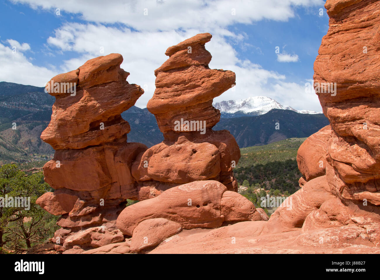 The Classic Overlook View of Garden of the Gods in Colorado Springs on a beautiful summer day with blue skies and white puffy clouds with Pikes Peak f Stock Photo