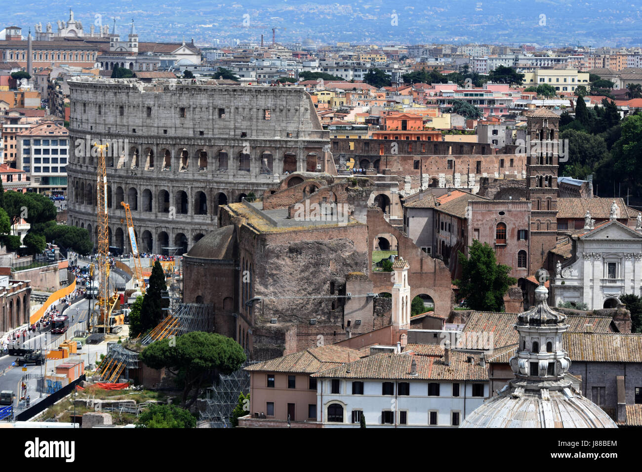 The Colosseum looks huge amongst the roof tops of Rome, Italy. Stock Photo
